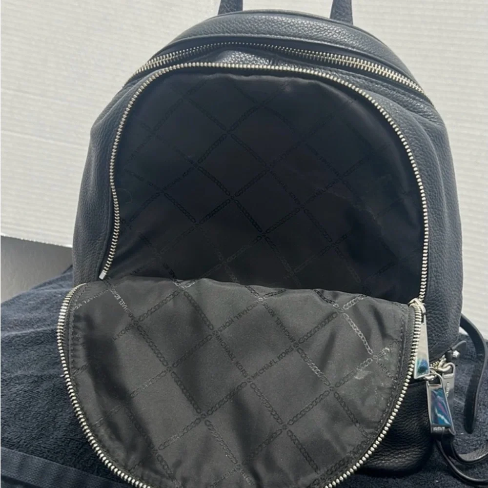 Michael Kors Rhea Medium Backpack in black pebbled leather  silver-tone dust bag